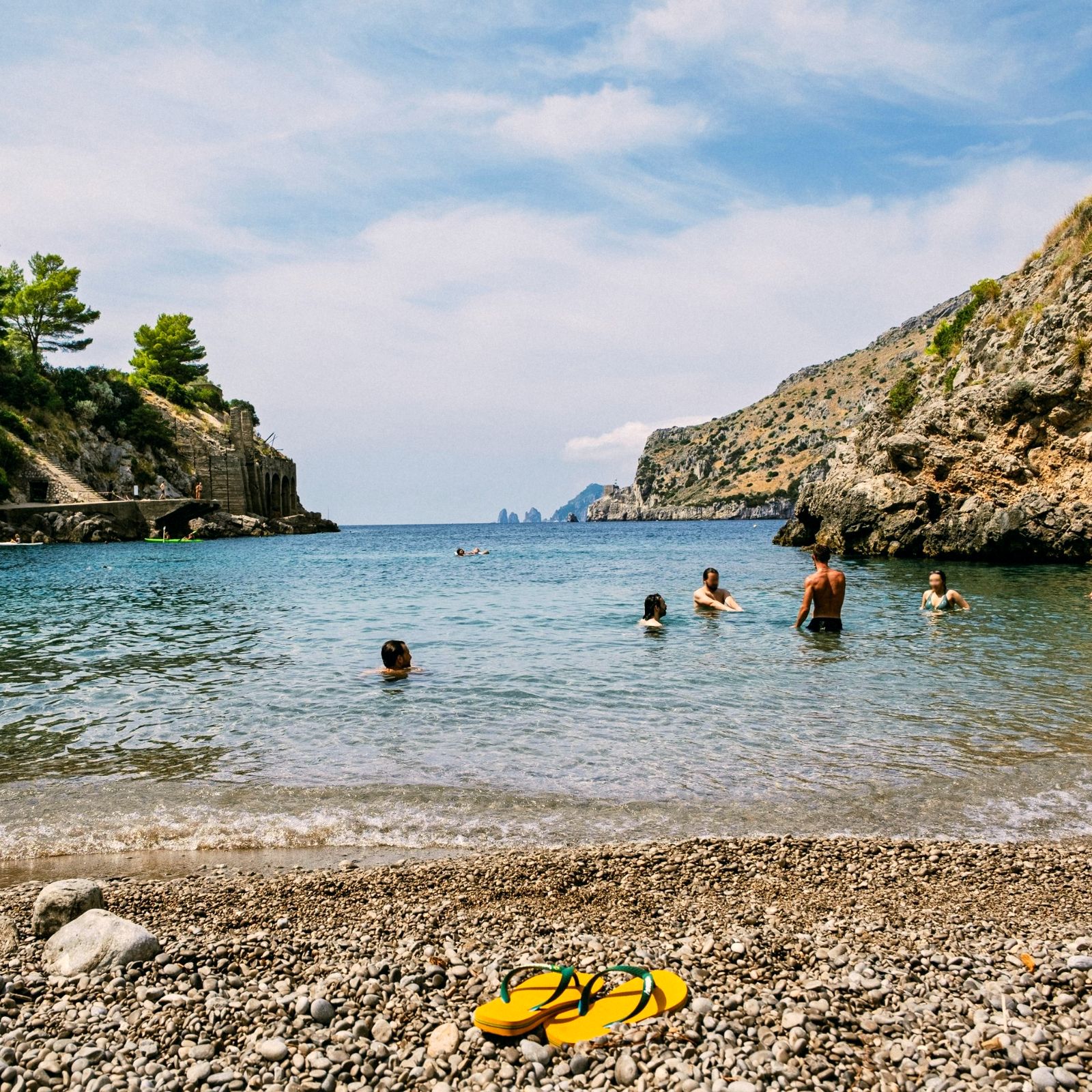 Swimmers in a rocky Mediterranean cove